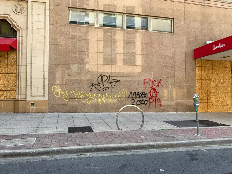 Tagged buildings (such as Neiman Marcus, pictured Sunday morning) appeared clean by Monday morning. - TAYLOR ADAMS