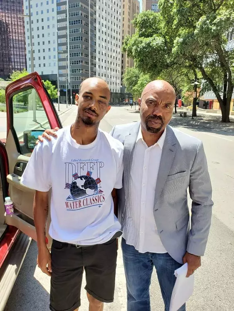 Saenz and his attorney Daryl Washington after Saenz was discharged from the hospital: Washington says they want more than a civil settlement from the city. They want the officer who shot him and those who didn't help Saenz as he bled on the sidewalk to face criminal charges. - COURTESY DARYL WASHINGTON