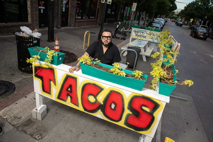 Chef-owner Regino Rojas is facing city fines for his impromptu taco tables outside Revolver Taco Lounge. - NATHAN HUNSINGER