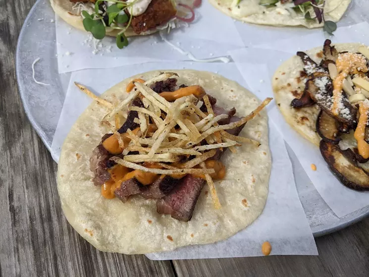 Steak frites taco at Resident Taqueria, with potato "fries" so crispy they don't sag. - BRIAN REINHART