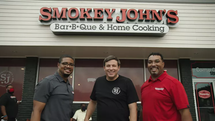 From left to right, Brent Reaves, Todd Graves and Juan Reaves, in front of the remodeled Smokey John's Bar-B-Que & Home Cooking. - COURTESY OF DISCOVERY PLUS