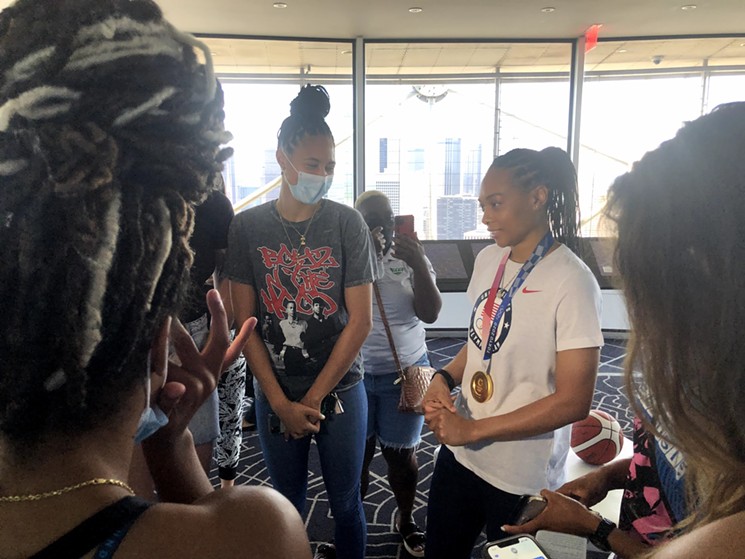 Olympic gold medalist and Dallas Wings guard Allisha Gray pals around with her Dallas teammates at a press conference on Wednesday at the top of Reunion Tower. - DANNY GALLAGHER