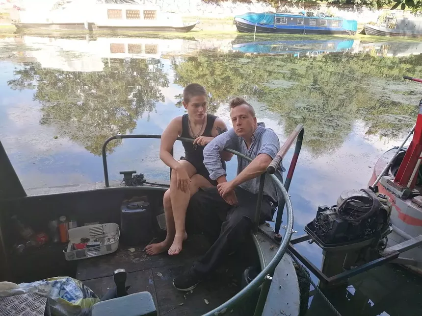 Sylvia Mann and Barrett Brown sit on their London houseboat. - HANNAH JOYSON