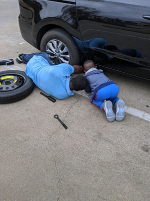 Lewis and his son work on a car together. - COURTESY DALILA REYNOSO