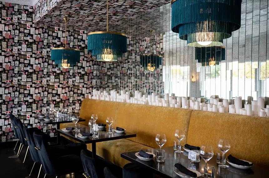 Vintage wallpaper on Indian playing cards mixes with modern touches in the dining room. - ALISON MCLEAN