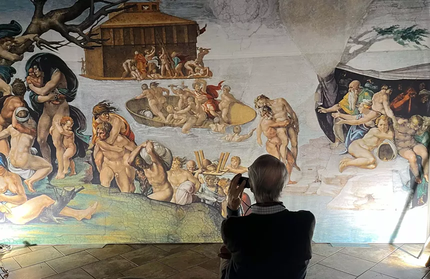 Jack Brennan listening to an audio narration of the history of Michelangelo's "The Flood" at Sistine Chapel: The Exhibition. - DANNY GALLAGHER