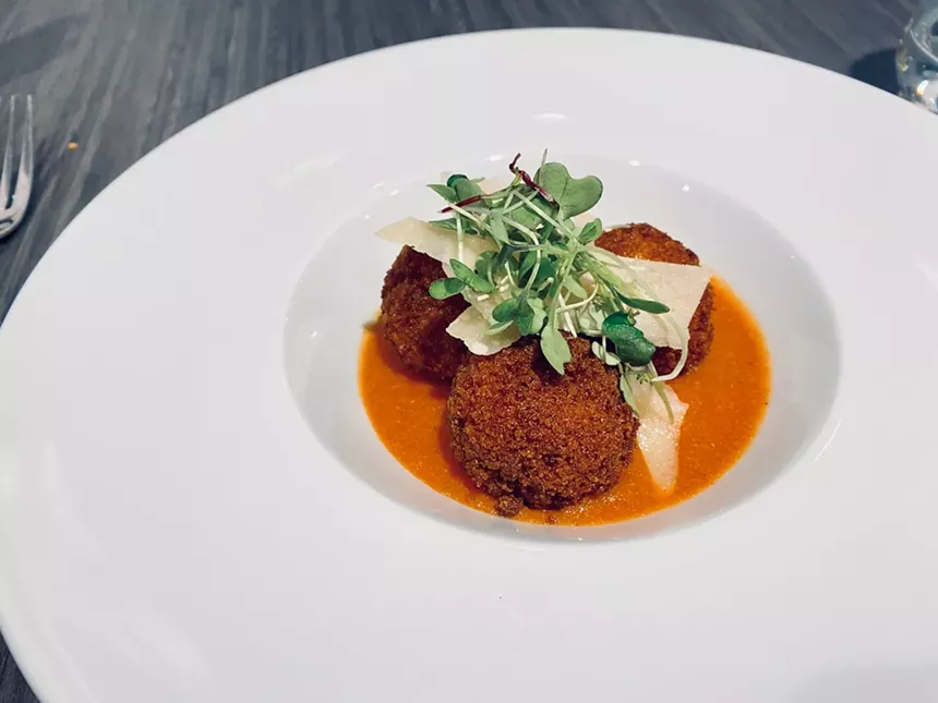 Derry's shrimp and grits are rolled in panko crumbs then fried and over a sausage tomato stew. - LAUREN DREWES DANIELS