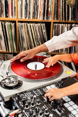 DJ Christy Ray spins a record with her son, Tatum. - KATHY TRAN