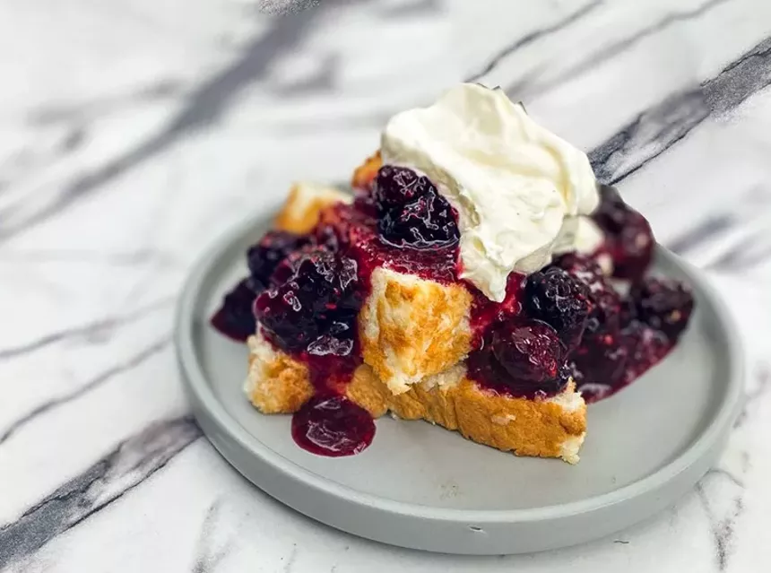 A slice of Market Moonshine angel food cake with blackberries and whipped cream rounded things off. - HANK VAUGHN