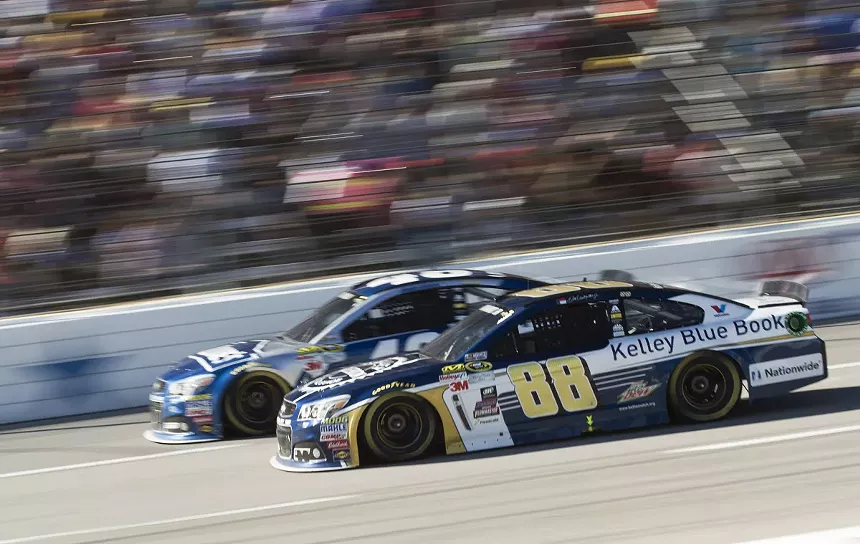 NASCAR driver Jimmy Johnson, top, edges out a lead against Dale Earnhardt Jr., bottom, at the Texas Motor Speedway. - RACHEL PARKER
