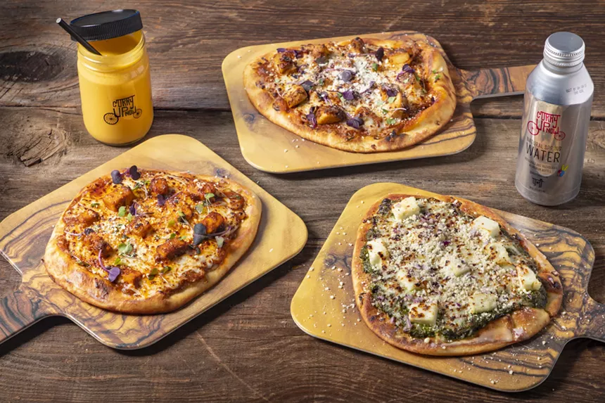The Naughty Naan section of the menu has pizza-like creations topped with traditional Indian flavors. - CURRY UP NOW