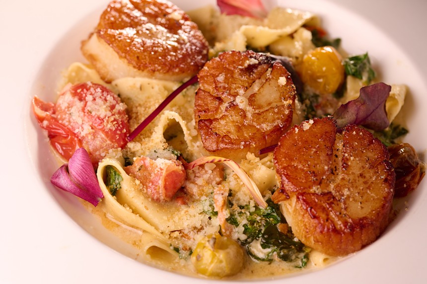 Seared scallops on a bed of pappardelle.