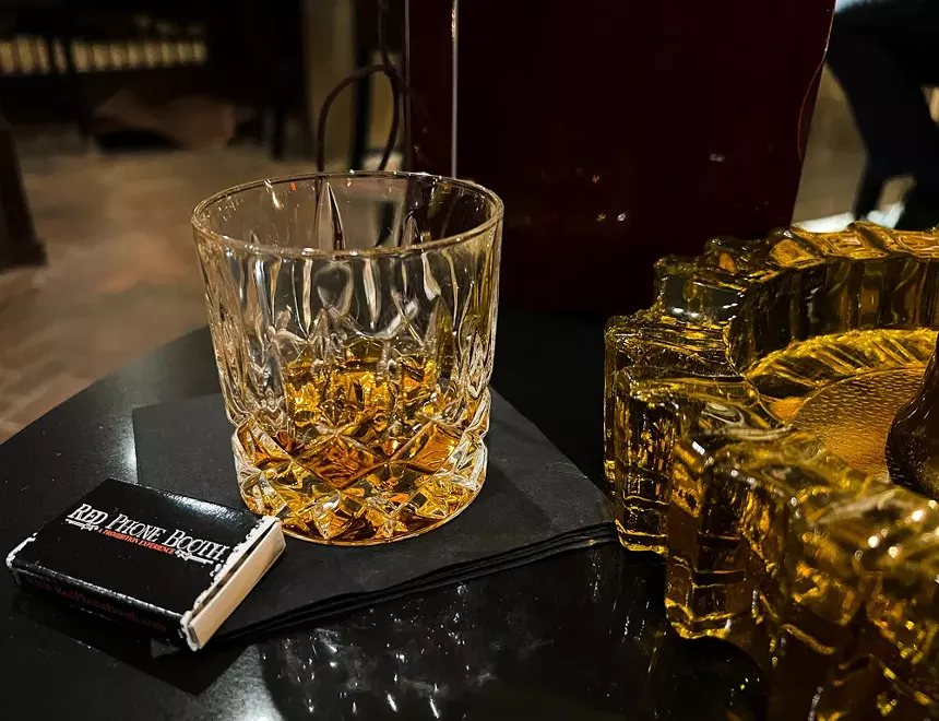 a pour of bourbon at Red Phone Booth.