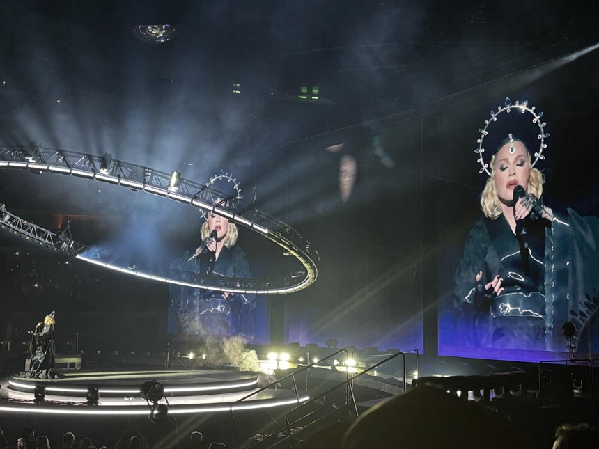 Madonna in a headpiece and black robe at her Dallas concert at American Airline on March 24.