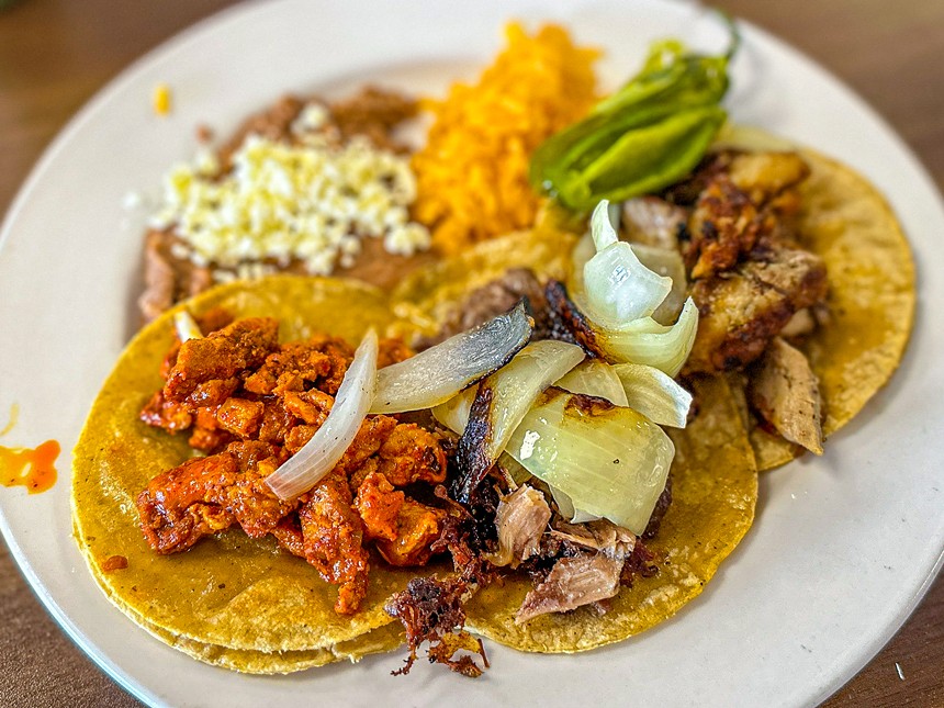 A taco plate  with pastor, barbacoa and carnitas