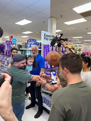 Dwayne "The Rock" Johnson signs Ruben Rodriguez's arm at a Dallas Target, and the gifts would keep coming.