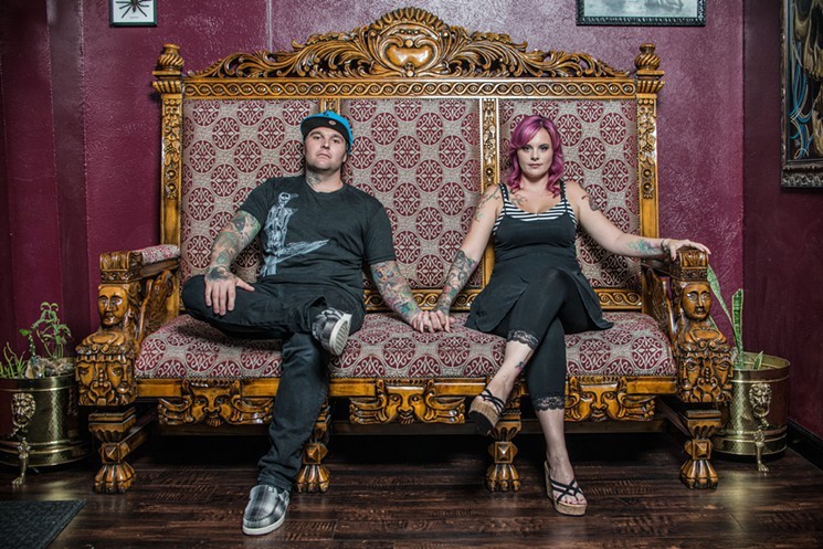 Liz Cook (right) sits with her husband, Cookie (left). They run Rebel Muse tattoo in Dallas, Lewisville and other states.