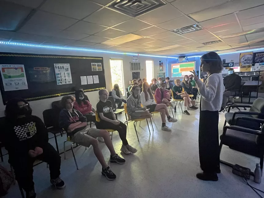 Emma Watson, right, speaking to Richard T. Quadri's theater class in 2022 at Sudie L. Williams Talented and Gifted Academy.