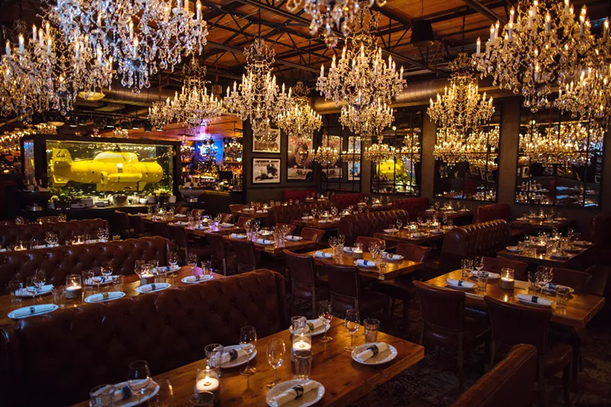 Town hearth's dining room with many chandeliers and one yellow submarine.