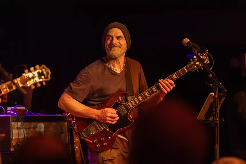 A group of musicians and band members on stage