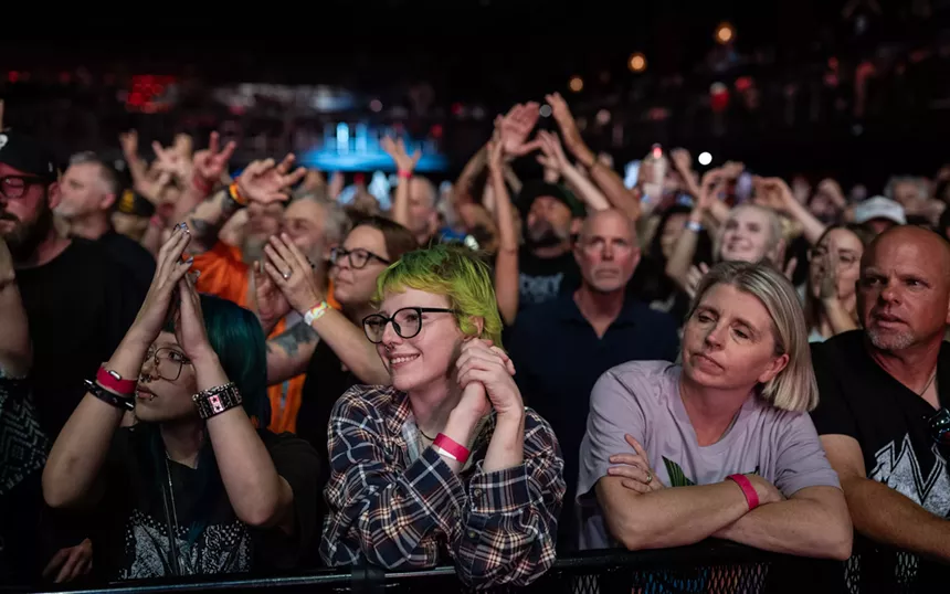 A crowd watching a band on stage