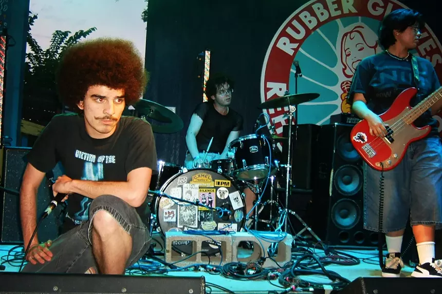 Three guys performing on stage
