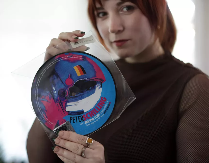 Woman showing off her vinyl collection