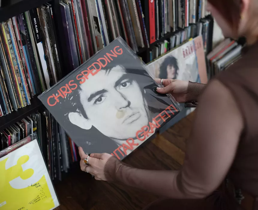 Woman showing off her vinyl collection