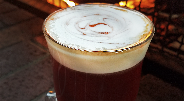 Whiskey Cake's Irish Coffee brings together Tullamore Dew Irish Whiskey, French-pressed coffee, cinnamon simple, freshly whipped cream, and a dash of Angostura bitters. - COURTESY OF WHISKEY CAKE