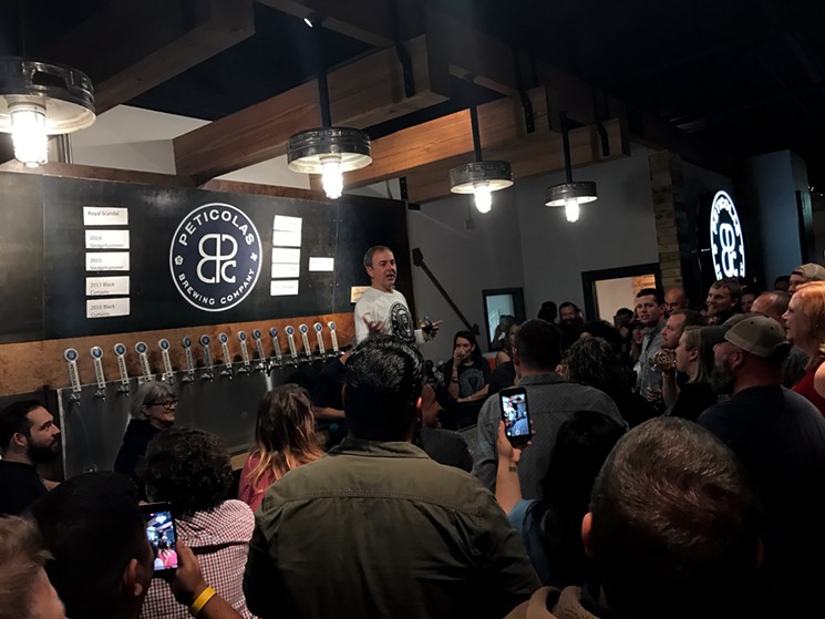 Peticolas Brewing Co. owner Michael Peticolas makes a toast during the grand opening party for the brewery's new taproom. - BETH RANKIN