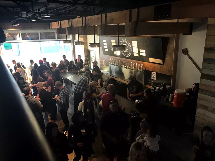 The 2,500-square-foot space boasts a massive bar, 16 taps and a second floor with table-top games and a stage for live music. - BETH RANKIN