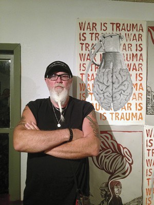 David Bass stands in front of artwork at Under the Hood Cafe in Killeen. - COURTESY DAVID BASS