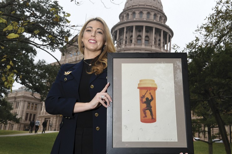 Kate Cochran-Morgan holds the painting that inspired Operation Trapped. - JOHN ANDERSON