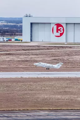 An Air Force training flight takes off from TSTC airport, with defense contractor L-3 Technology's hangar in the background. - JOE GRIFFIN