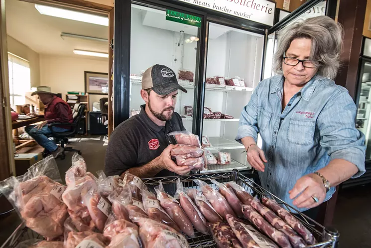 Grady Phelan helps Wendy Taggart shelve chickens from his poultry farm, Cobb Creek Farm. - CAN TURKYILMAZ