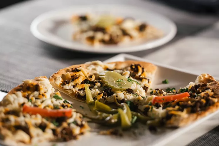 Sujuk “pies,” ultra-thin-crust Lebanese pizzas with toppings like akawi, a briney Palestinian cheese, at Zatar. - KATHY TRAN