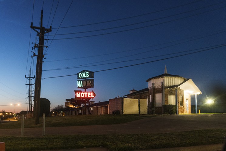 The half-lit sign illuminates the motel, Cole Manor on Harry Hines. - DANIEL DRIENSKY & SARAH REYES