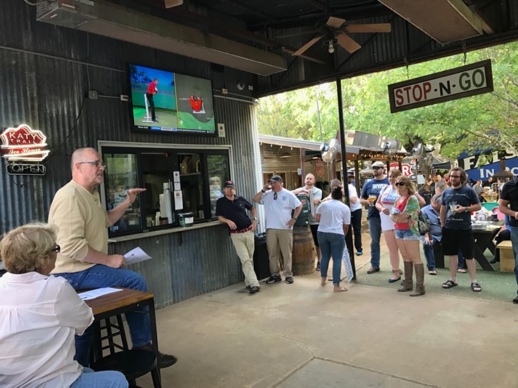 Randall White, in yellow, speaks to a crowd of about 50 people at Katy Trail Ice House during a meeting about the proposed late-night overlay that could force some Dallas bars to close at midnight. - BETH RANKIN