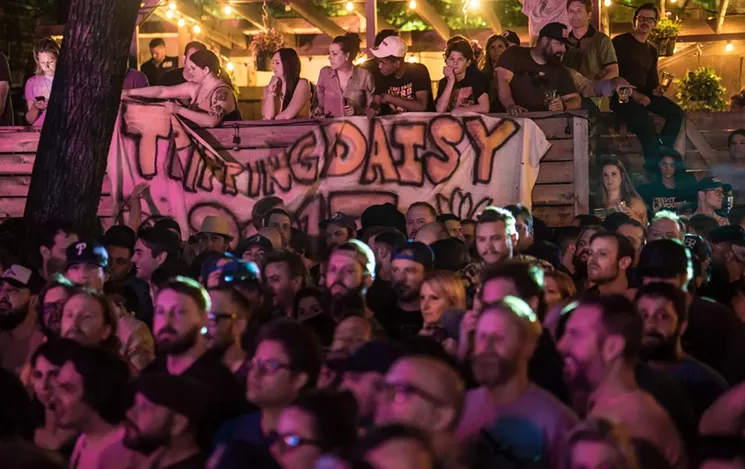 The show was at capacity, so fans turned up to Off the Record next door and peeked over the fence, dropping down Tripping Daisy signs. - MIKE BROOKS