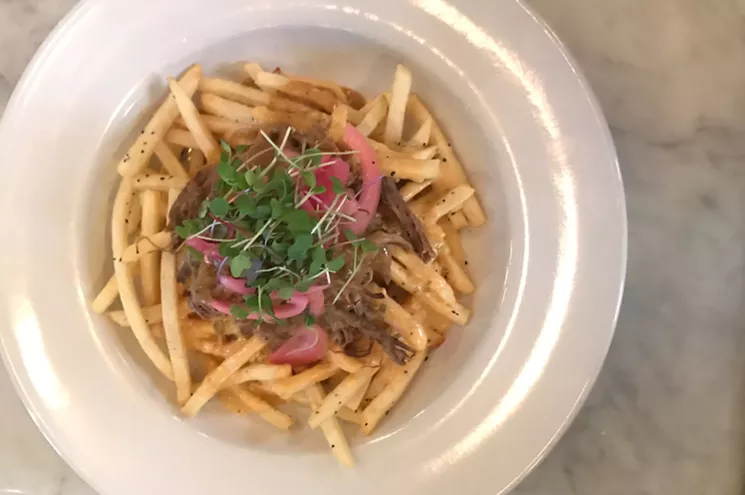 The Texas poutine ($14) includes ho-hum french fries covered in a "Southwest cheese sauce." - BETH RANKIN