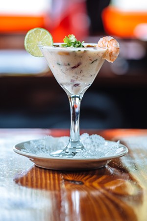 Leche de tigre is a classic and blazingly acidic ceviche treatment, combining the citrus with diced red onions, cilantro and a few chiles. - KATHY TRAN