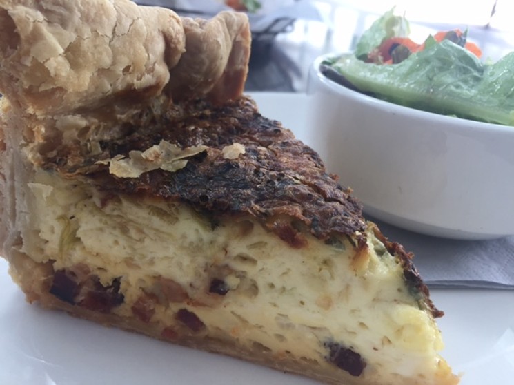 The quiche is a deep-dish beauty, sitting as tall as an 8-inch layer cake in a diner case. - KATHRYN DEBRULER