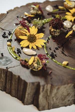 Sunflower, sumac, elderberry, bee balm, marigold, mustard leaf and dewberry are used in the plating. - KATHY TRAN / WOOD BOARD COURTESY WRIGHT EDGE