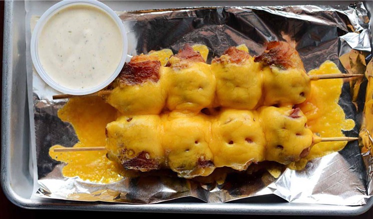 Blues Burgers has skewers of jalapeño- and bacon-wrapped tots. - BLUES BURGERS