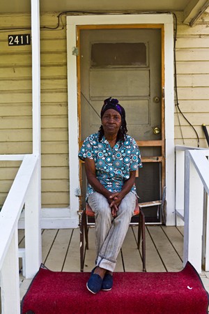 Brown sits on her front porch. - MARK GRAHAM