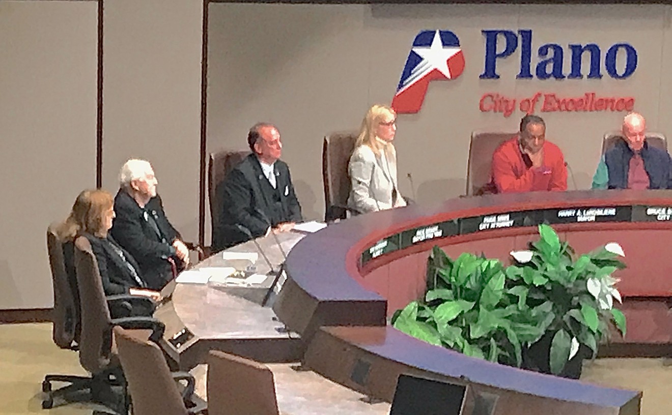 Plano City Council member Tom Harrison, second from left, listens as his fellow council members urge him to resign for publishing anti-Islamic posts on his Facebook page.