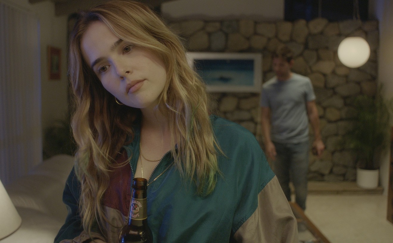 In Flower, Zoey Deutch (foreground) plays Erica, a troubled teen acting on instinct who makes it her mission to blackmail a teacher (Adam Scott) in order to make her stepbrother feel better.