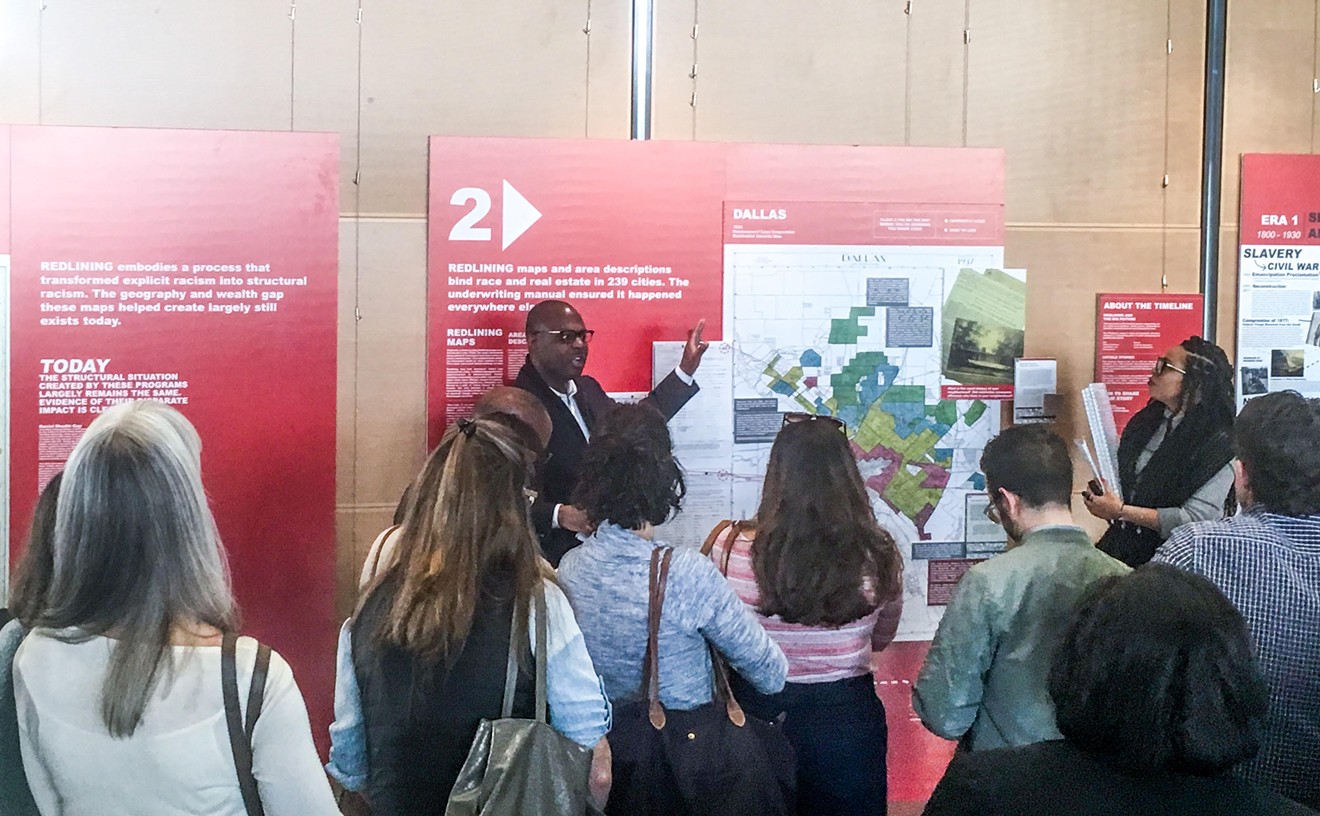 Victor Obaseki, Dallas' first equity officer, gives a tour of the Undesign the Redline exhibit at Dallas City Hall, produced by a New York nonprofit.