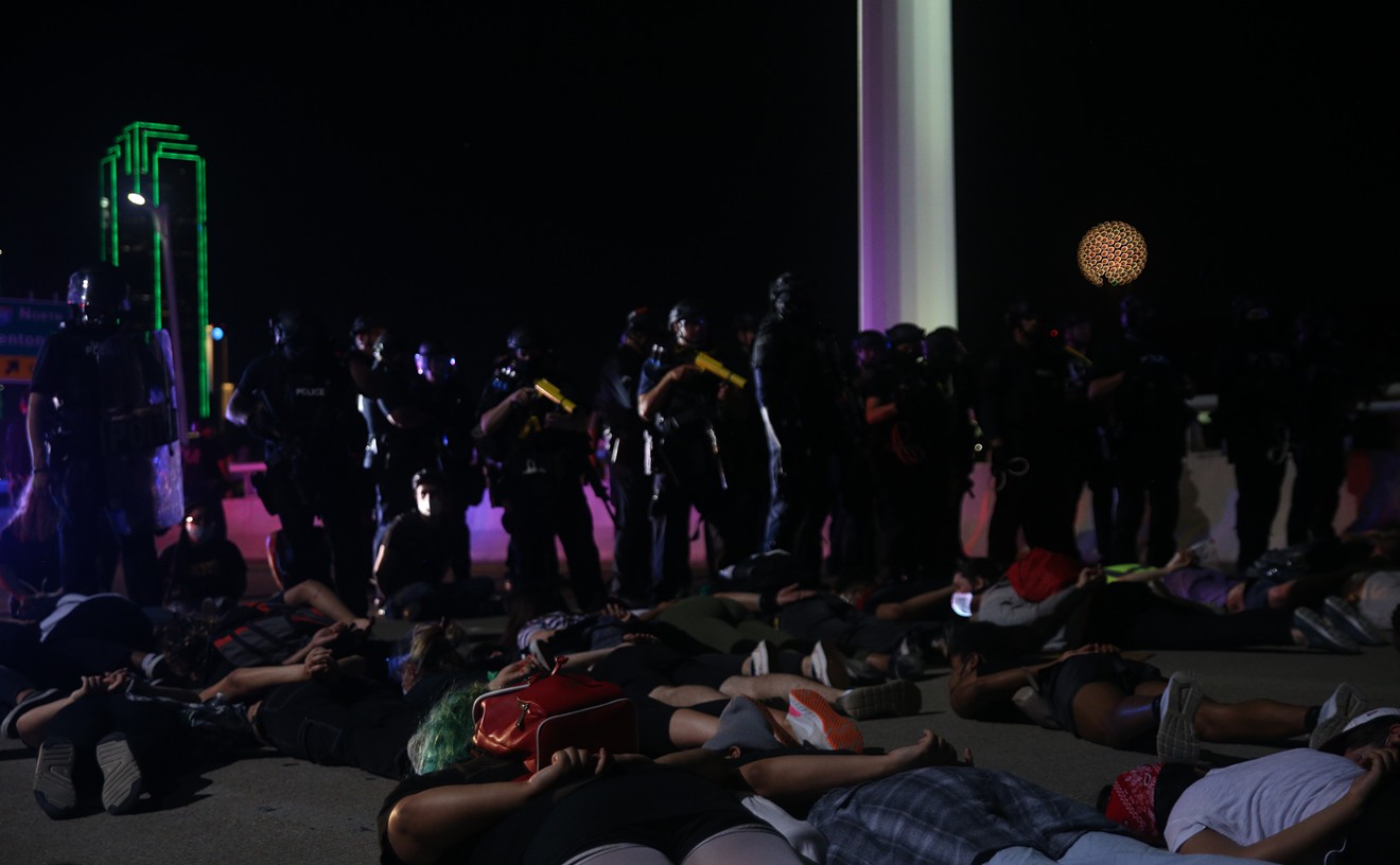 Protesters lie on their stomachs waiting to be arrested by police after marching on the Margaret Hunt Hill Bridge June 1.
