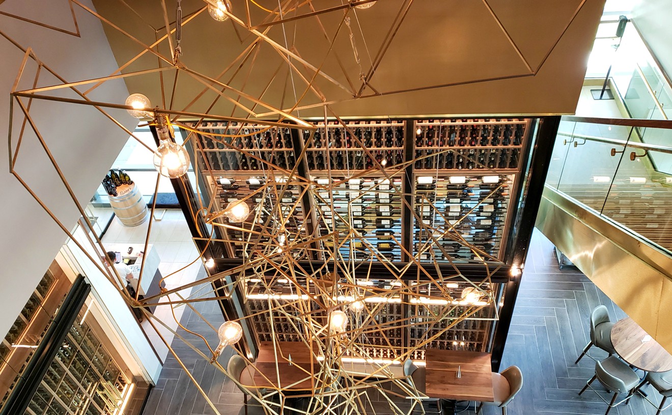 Looking down from upstairs gives you a dizzying yet glorious view of the staircase, chandelier and wine tower inside Perry's new location.